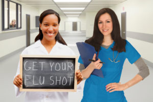 2 Nurses with sign-Get your flu shot