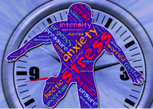 Clock with cutout of a person with stress words all over it