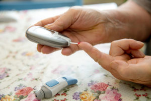 Woman with Type 2 Diabetes checking glucose level